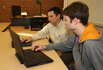 Dylan Cawthorne and Joe DeCarolis review energy systems data.