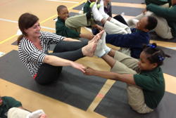 Jessica Hooks '03 participates in a YogaPowerPlay-led class with students at New Orleans' Crocker Elementary School in February 2014.