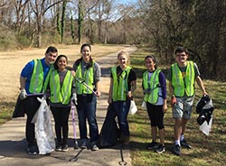 Members of the Service Raleigh 2017 Committee beautify a Capital Area Greenway trail