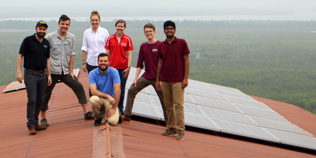 Evan Grant installing solar array as part of an NC State Engineers Without Borders project in Freetown, Sierra Leone