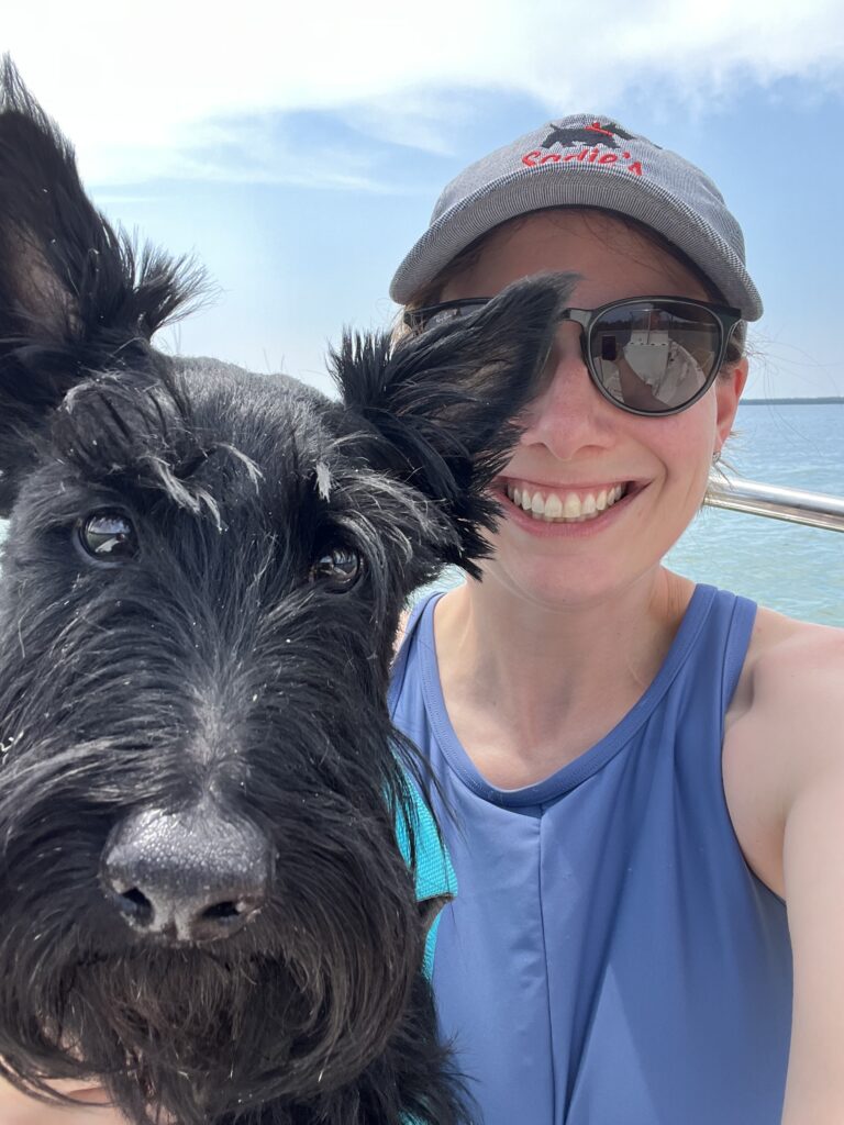 Chasta and a black dog on a boat